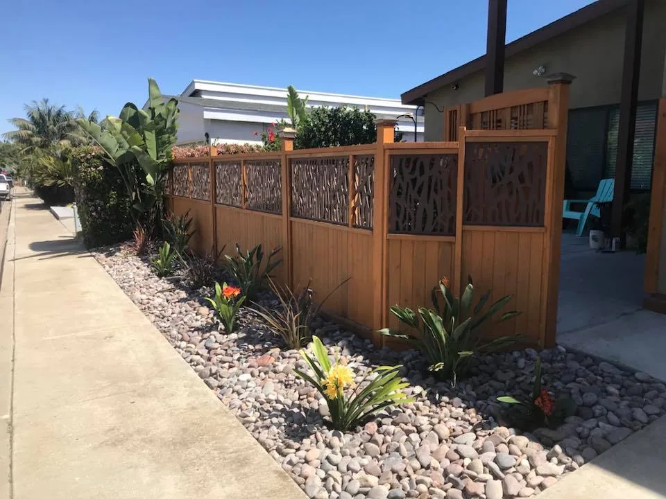 Clean perimeter landscape with decorative rock ground cover and drought-tolerant plantings