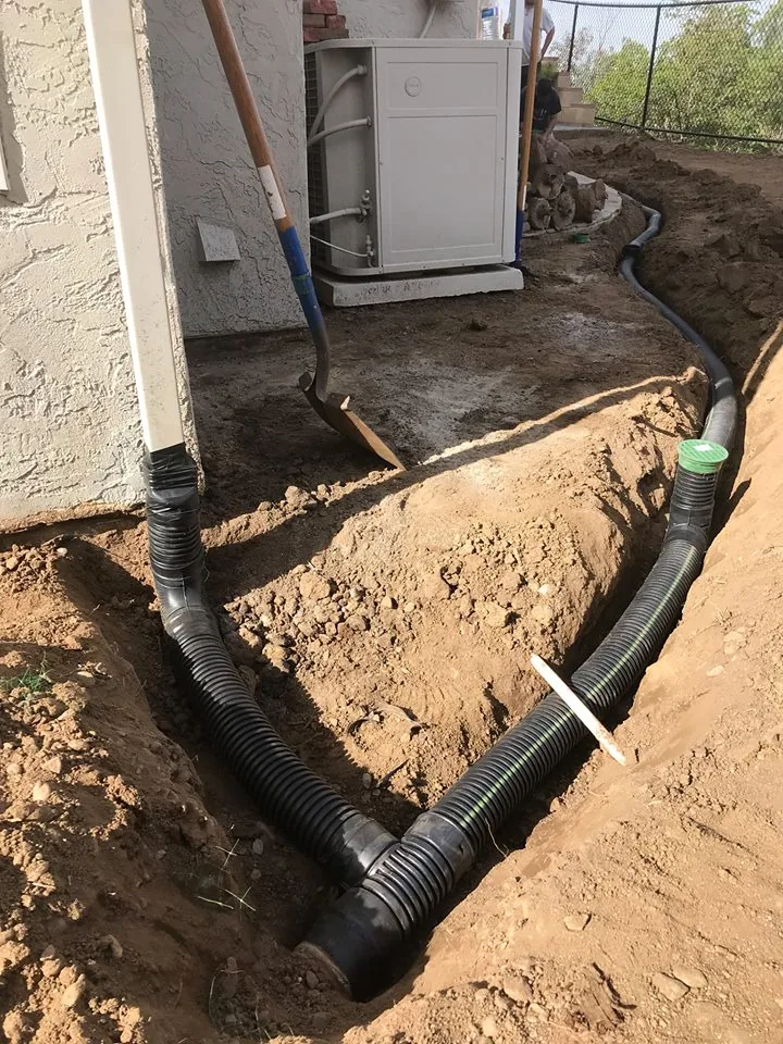 Commercial French drain perforated pipe trenching in El Cajon CA by Burgio Landscape Services