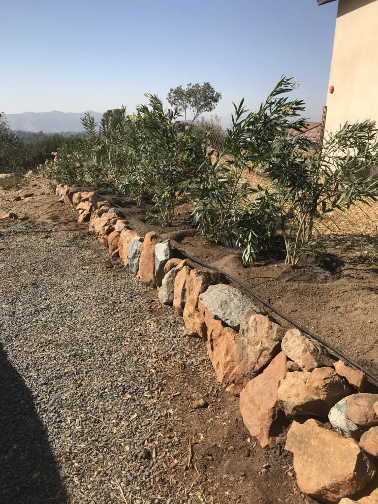 Segmental block retaining wall terracing steep slope in Santee CA by Burgio Landscape Services